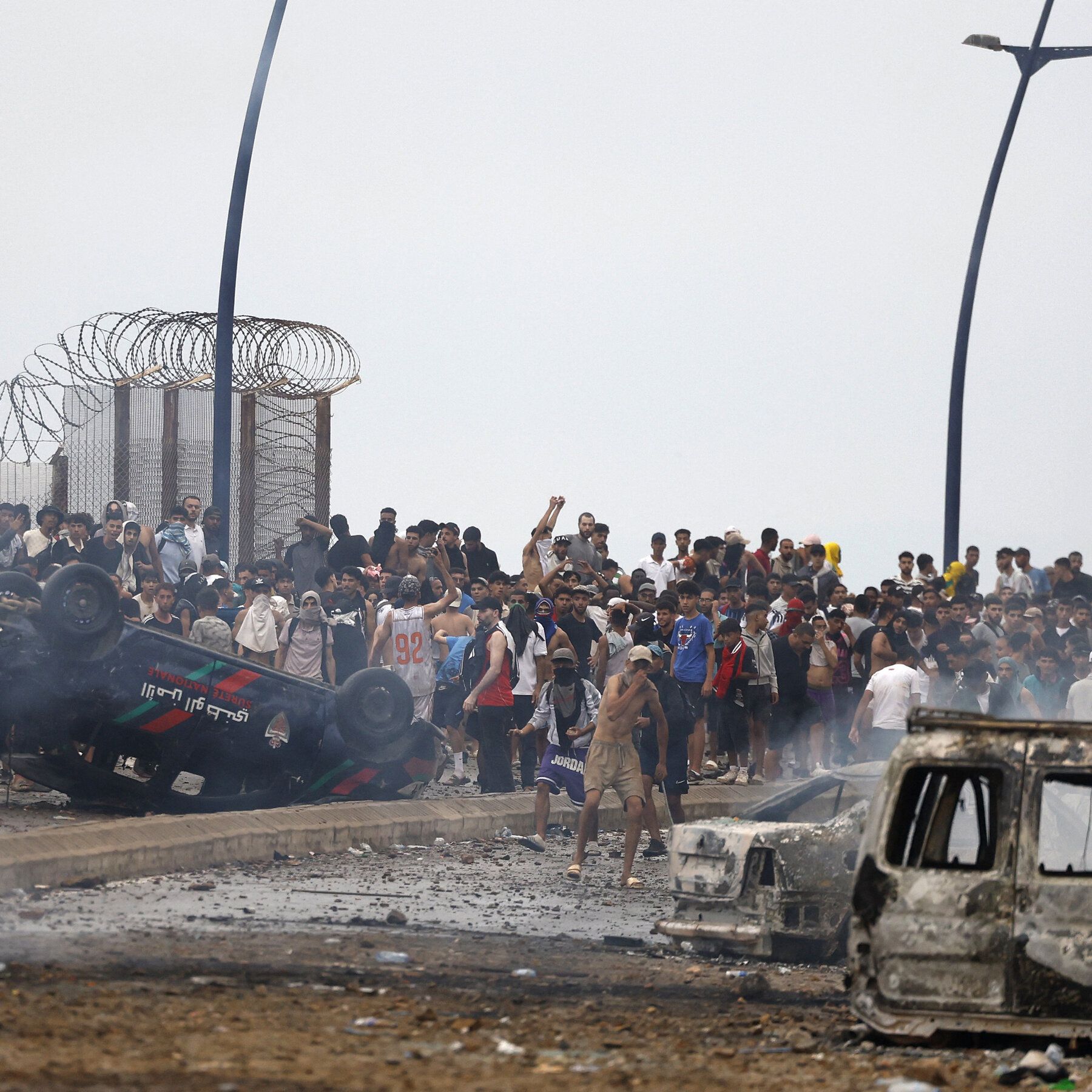 Migrants near the Spain-Morocco border on Friday after tens of thousands entered Ceuta, with most later returning. - The New York Times