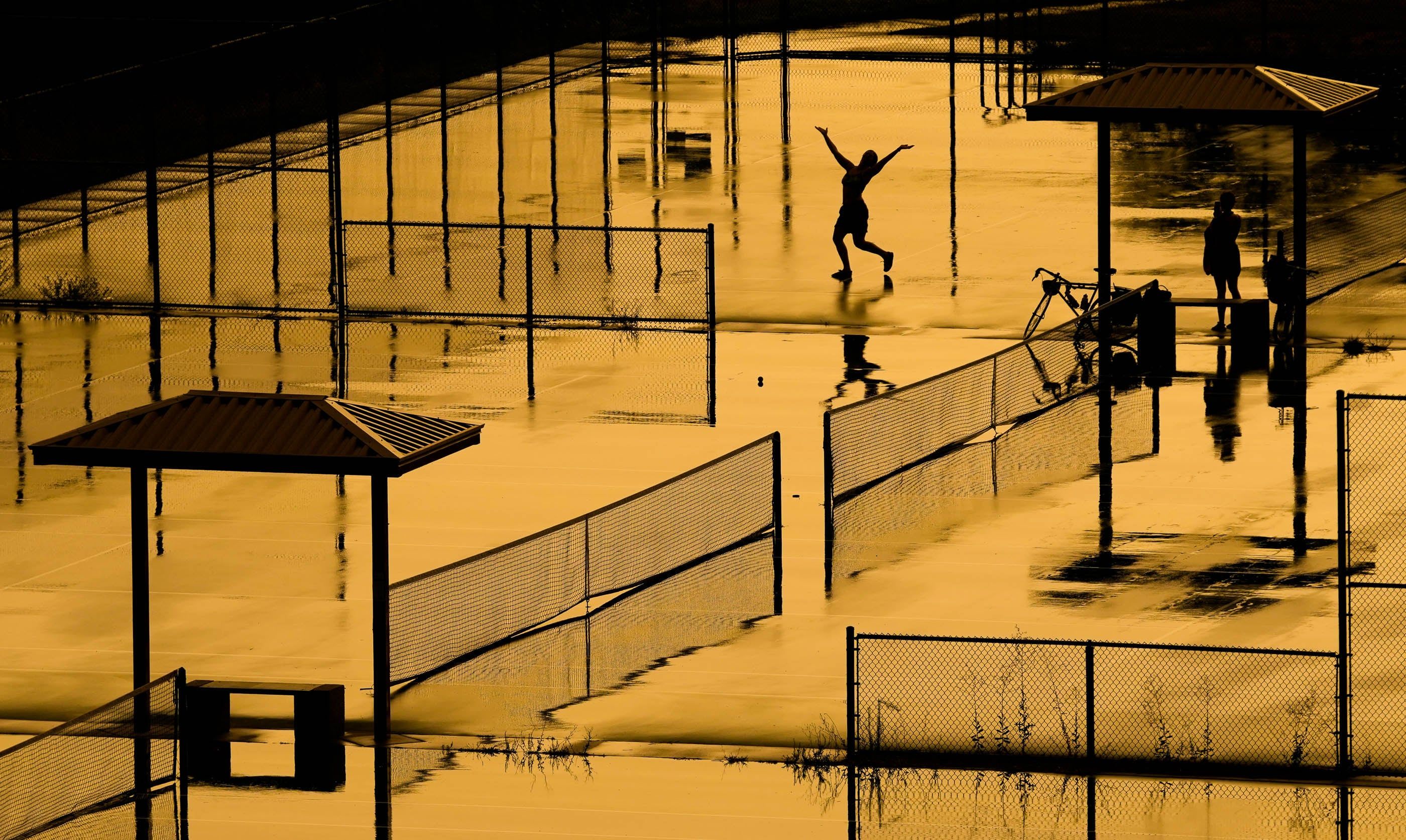 People dance in the rain at Eleventh Avenue Park in Salt Lake City on July 29 as Utah braces for another weekend of triple-digit temperatures. - Francisco Kjolseth | The Salt Lake Tribune