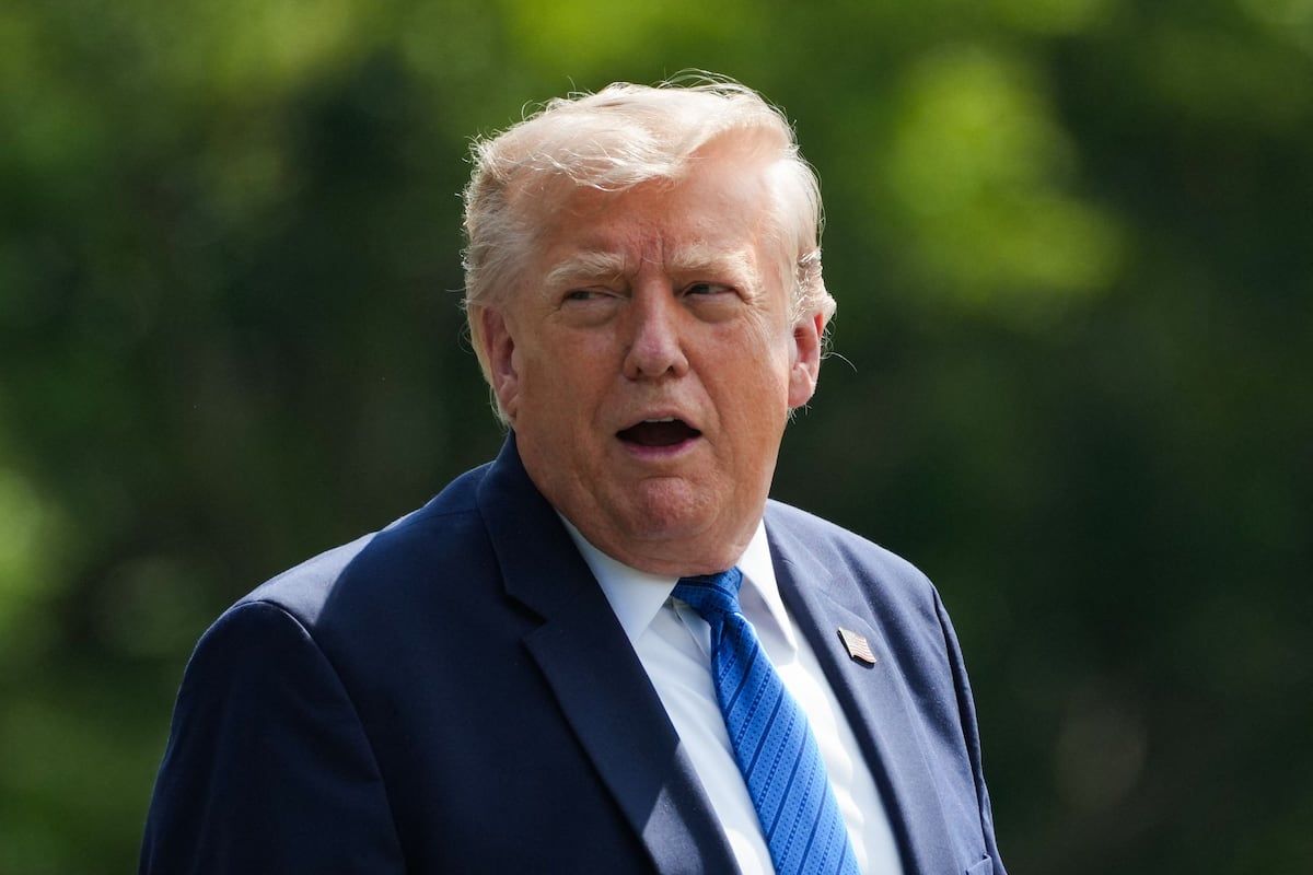 President Trump gestures before boarding Marine One after a Cabinet meeting at Camp David on July 31, 2026. - Nathan Howard/POOL/AFP