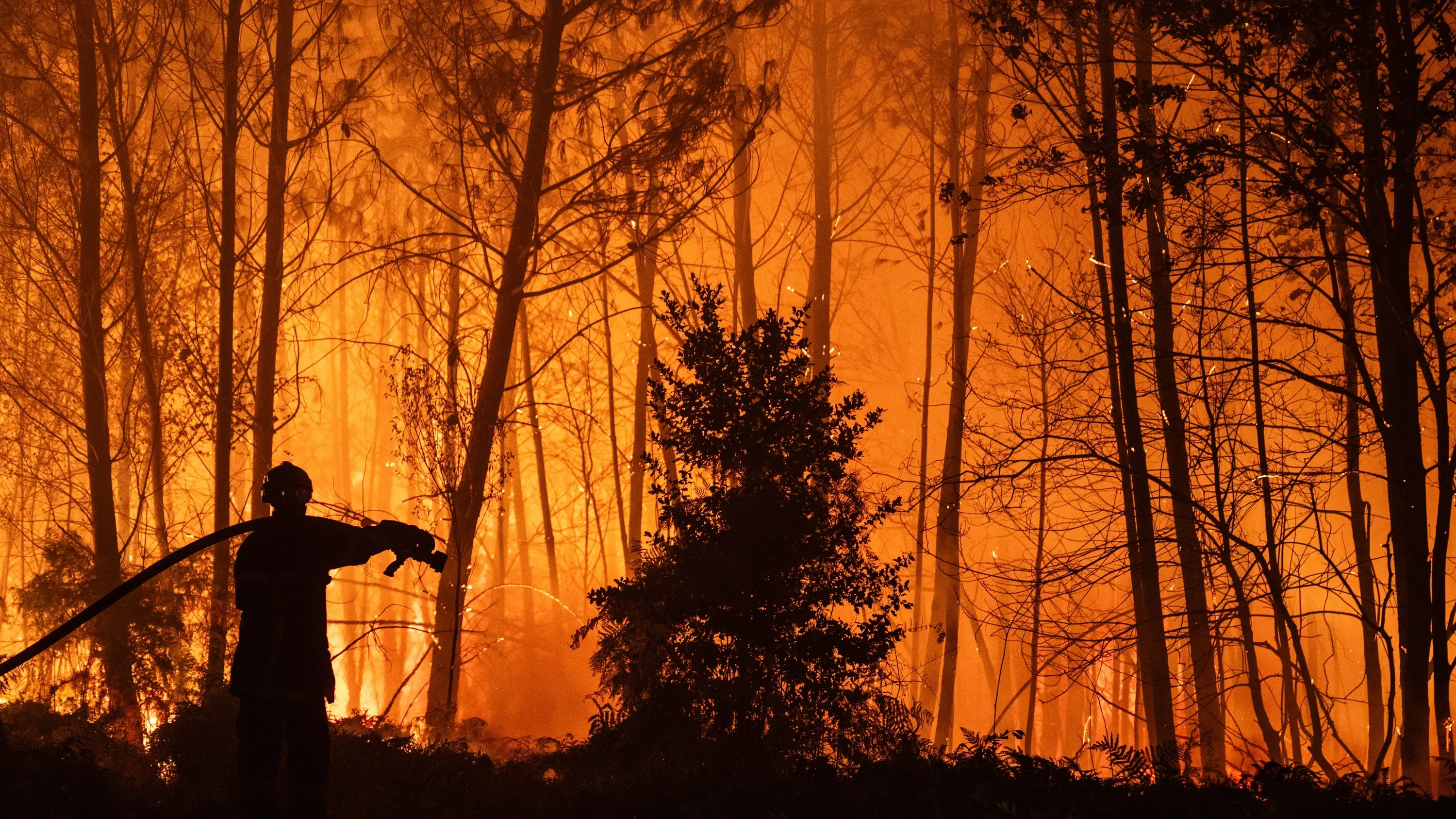 Firefighters battle flames in Arès in France’s Gironde region. - EPA