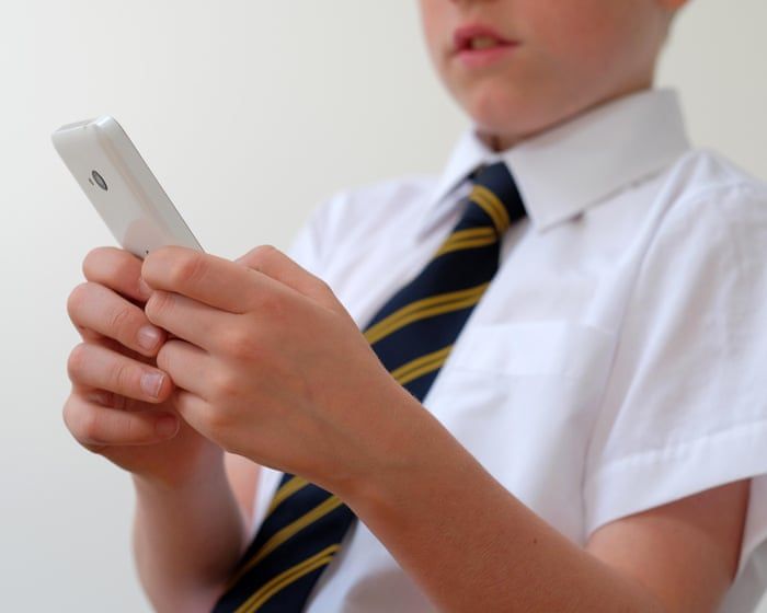 A child using a phone, accompanying coverage of the social media and school performance study. - True Images/Alamy