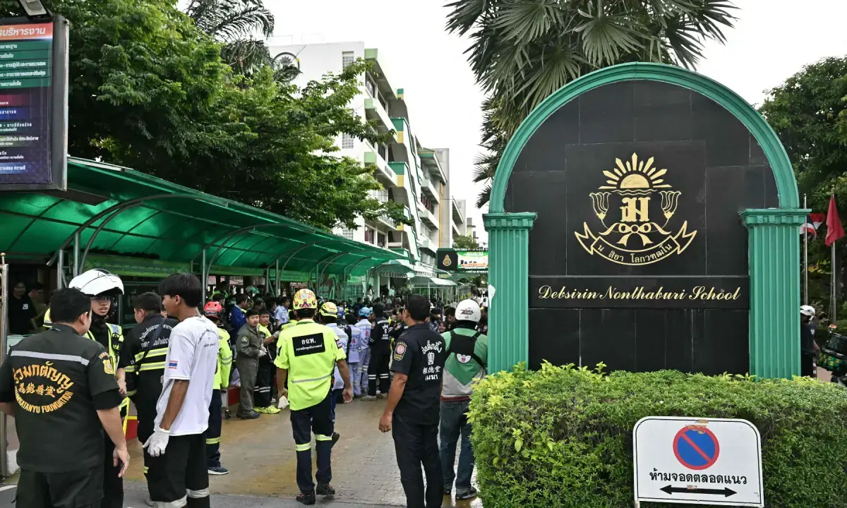 Emergency responders stand outside a school following a shooting in Bang Kruai district, Nonthaburi province, north of Thailand's capital Bangkok, on Aug. 7, 2026. - AFP