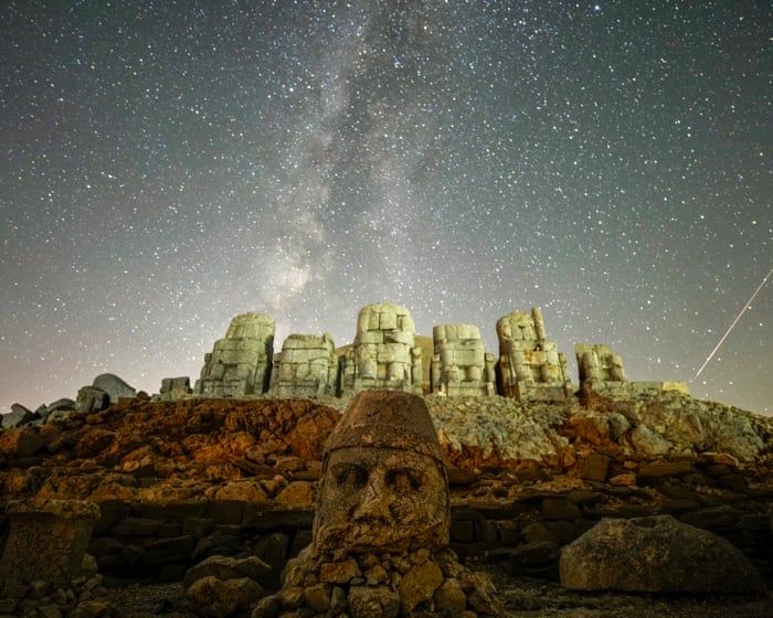 Ancient statues are seen during the Perseid meteor shower atop Mount Nemrut in southeastern Turkey in August 2024. - Emrah Gürel/AP