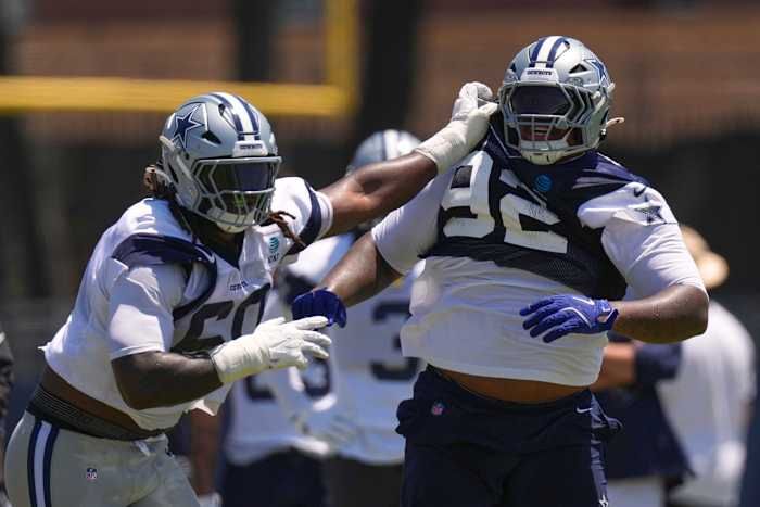Dallas Cowboys offensive tackle Tyler Guyton holds defensive tackle Quinnen Williams back during training camp in Oxnard, California, on Aug. 1, 2026. - AP Photo/Mark J. Terrill