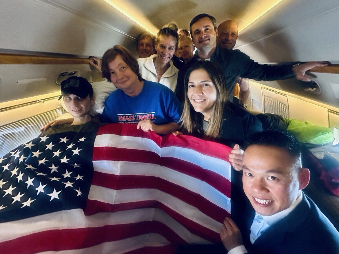 Robert Gilman, at far left, on a flight home to the United States on Aug. 11, 2026, after spending years in detention in Russia. - President Donald Trump/Truth Social via NBC Boston