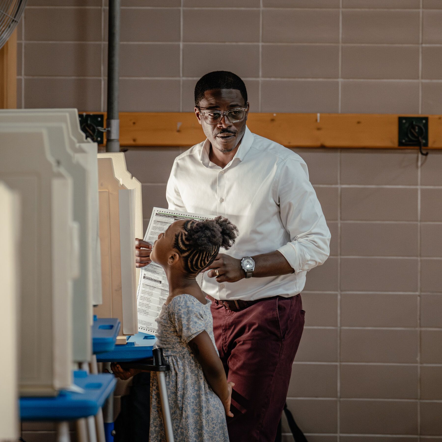 David Crowley, the Milwaukee County executive, casting his ballot alongside his daughter at Milwaukee German Immersion School on Tuesday. - nytimes.com