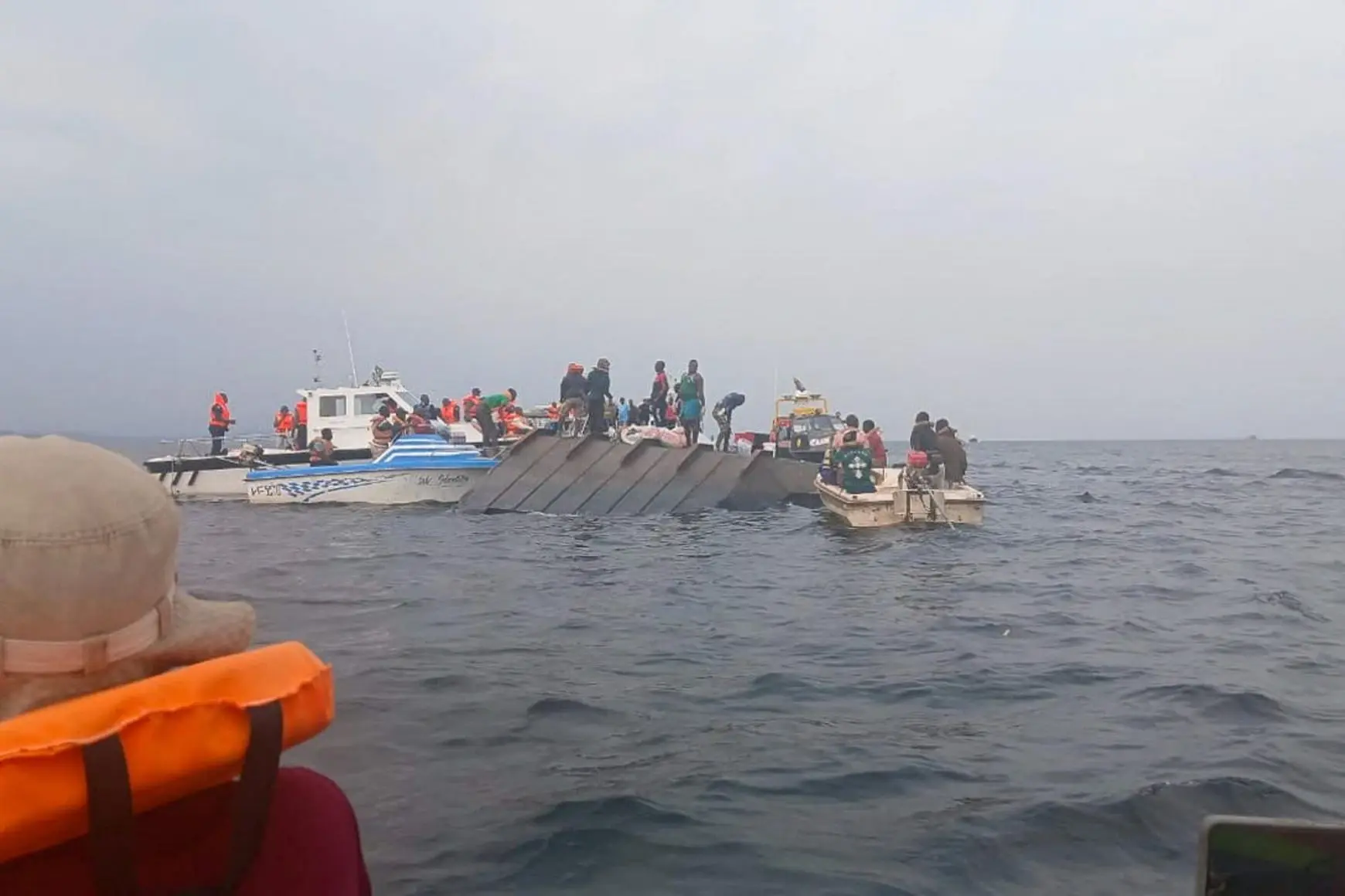 Rescue workers and local boat operators take part in search and recovery operations near the overturned passenger ferry on Lake Kariba on August 12, 2026. - Admore Mbonda/Reuters