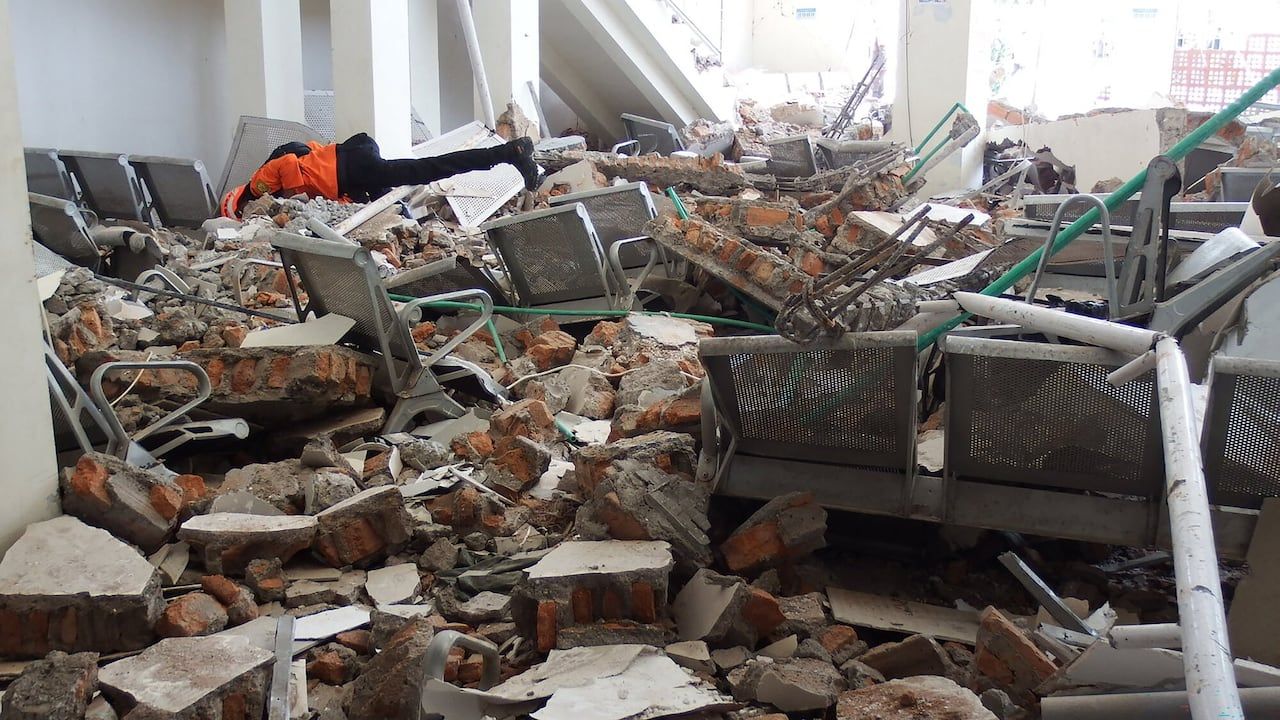 A rescue team searches for victims in the ruins of the Laurensius Say Port in Maumere, Sikka, East Nusa Tenggara, after the magnitude 7.7 earthquake struck Flores Island. - Arnold Welianto/AFP