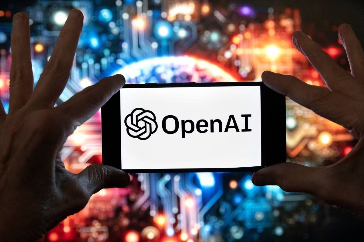 The OpenAI logo is displayed on a cell phone in front of an image generated by ChatGPT's Dall-E text-to-image model, Dec. 8, 2023, in Boston. - AP Photo
