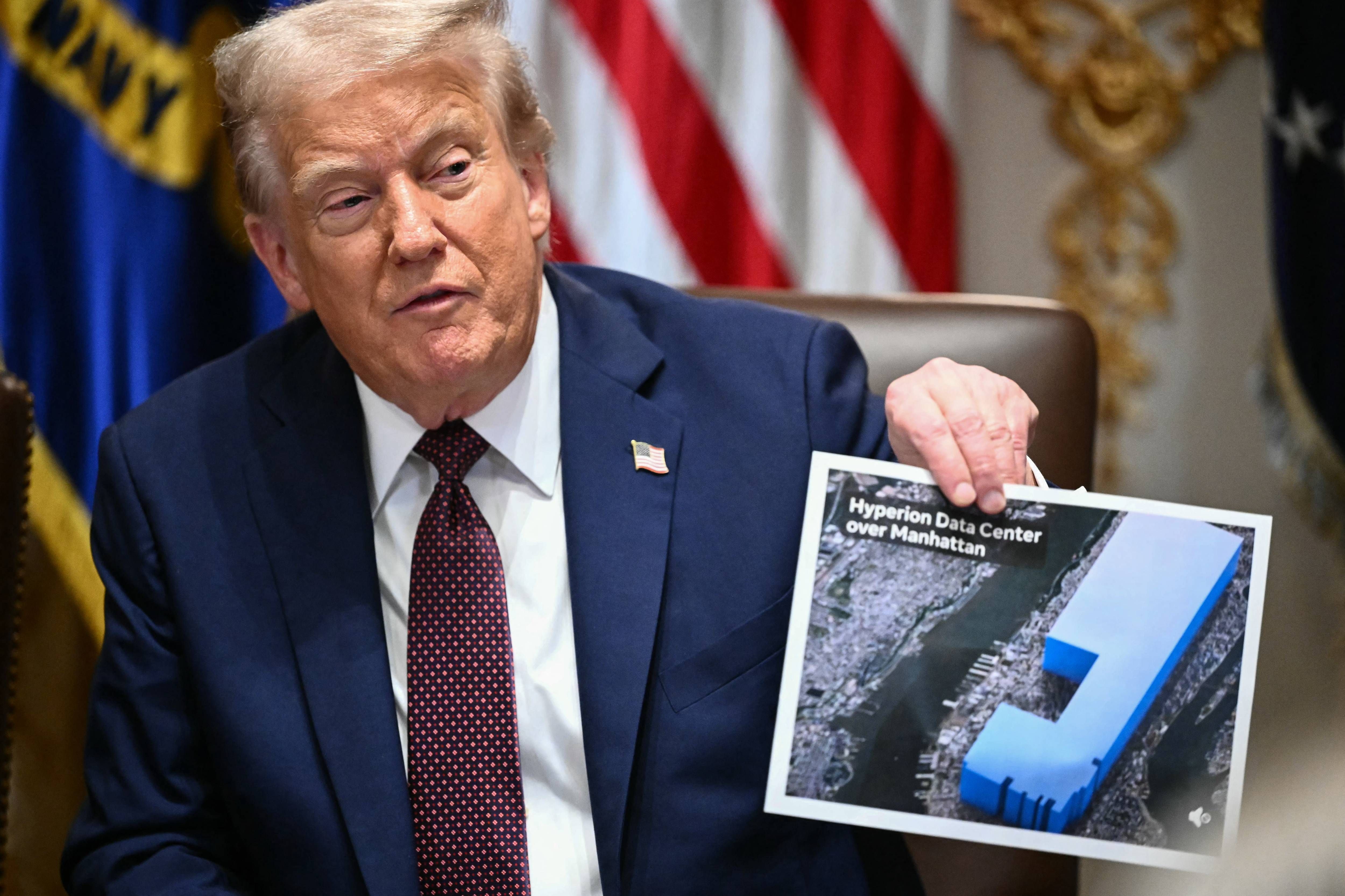 President Trump holds an image showing the size of Meta's data center in Washington, D.C., in 2025. - commondreams.org