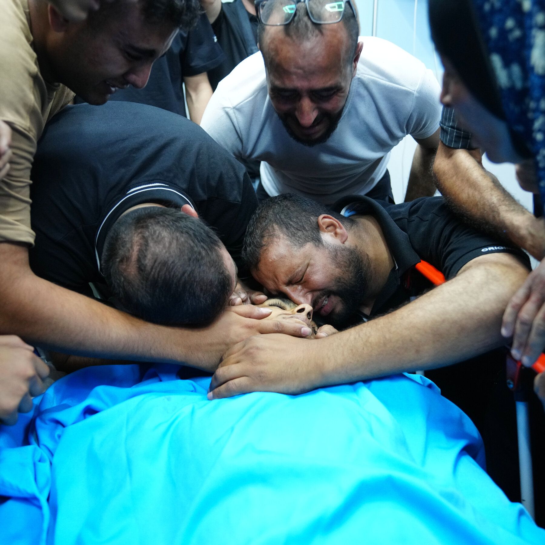 Mourners with the body of Kareem Shlaldeh at a hospital in the West Bank city of Hebron, on Friday. - nytimes.com