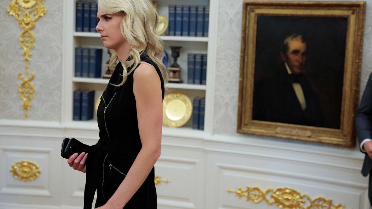 Natalie Harp listens as President Trump signs legislation in the Oval Office. - alternet.org