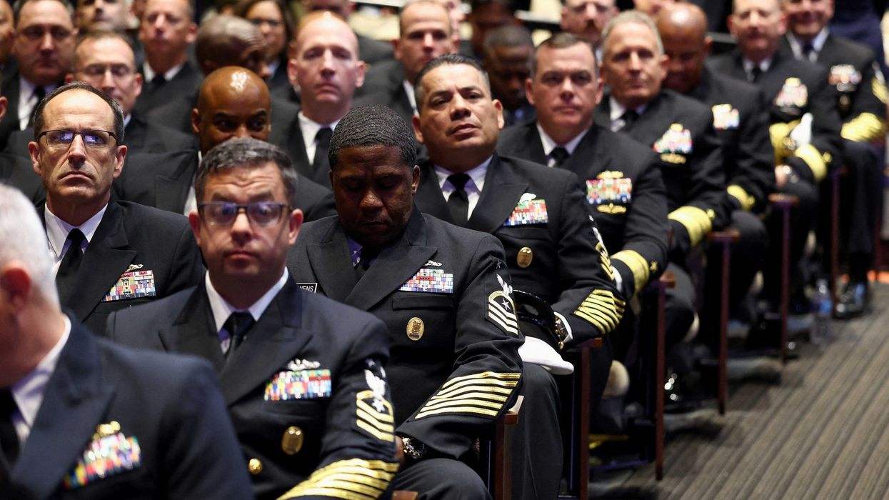 Members of the military wait for President Donald Trump to arrive for a meeting convened by Defense Secretary Pete Hegseth. - alternet.org
