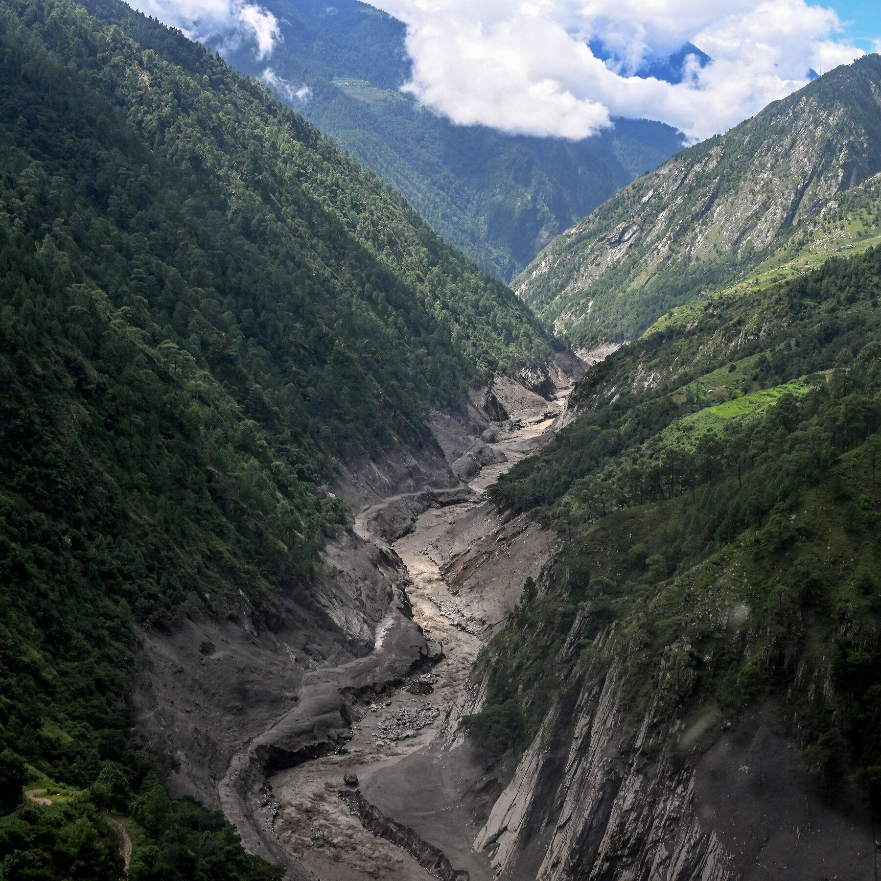 Mud-laden water and debris surges through the widened channel of the Bhotekoshi River in northern Nepal’s Rasuwa district. - nytimes.com