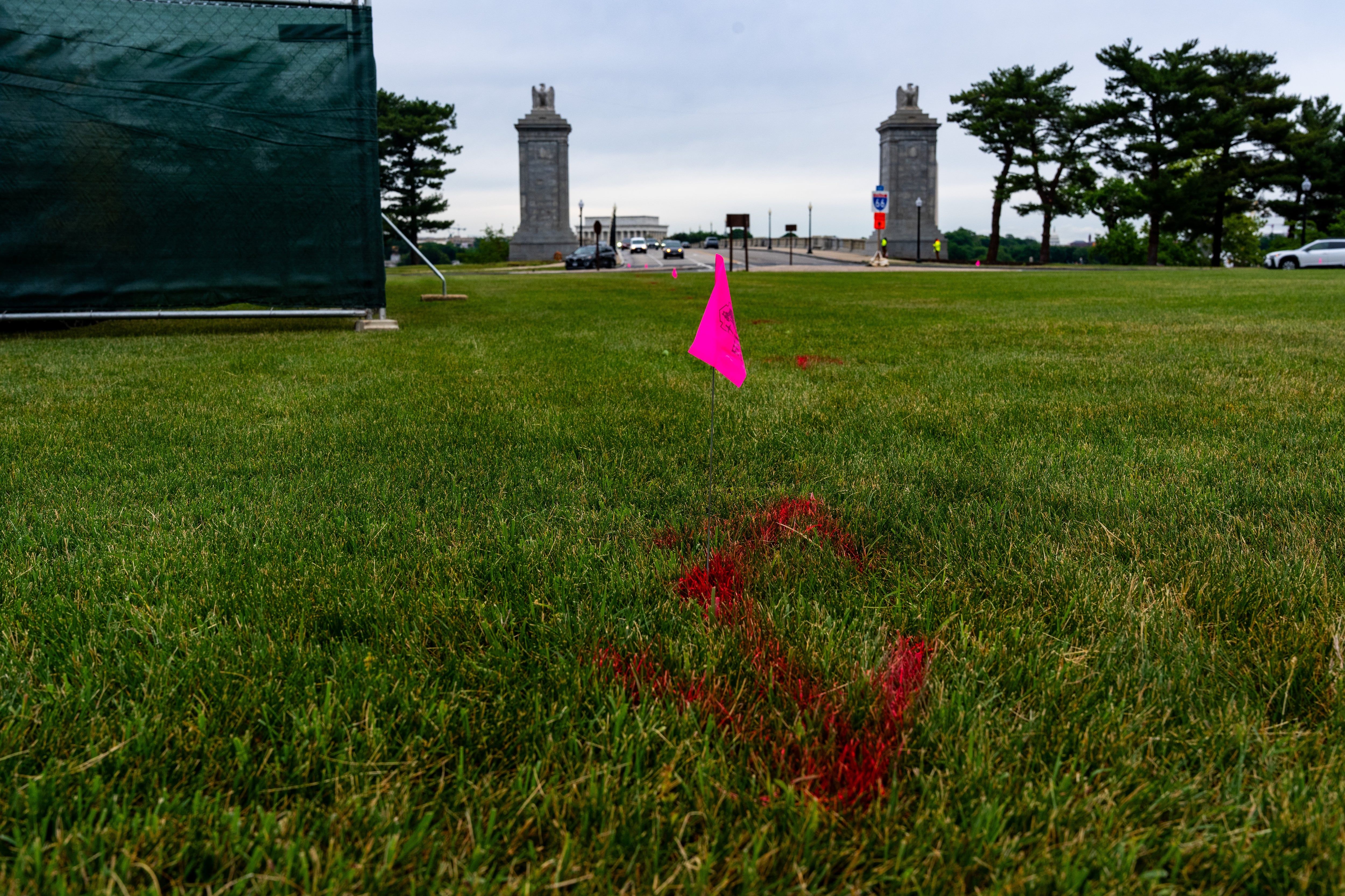 Flags mark Memorial Circle, where President Trump has proposed building an arch to commemorate the United States' 250th anniversary. - AP Photo/Alex Brandon