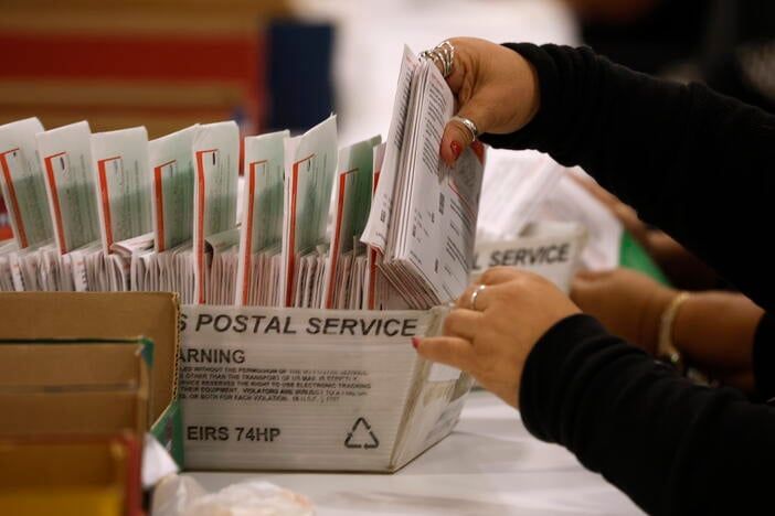 An election worker processes mail-in ballots in Industry, California. - Getty Images