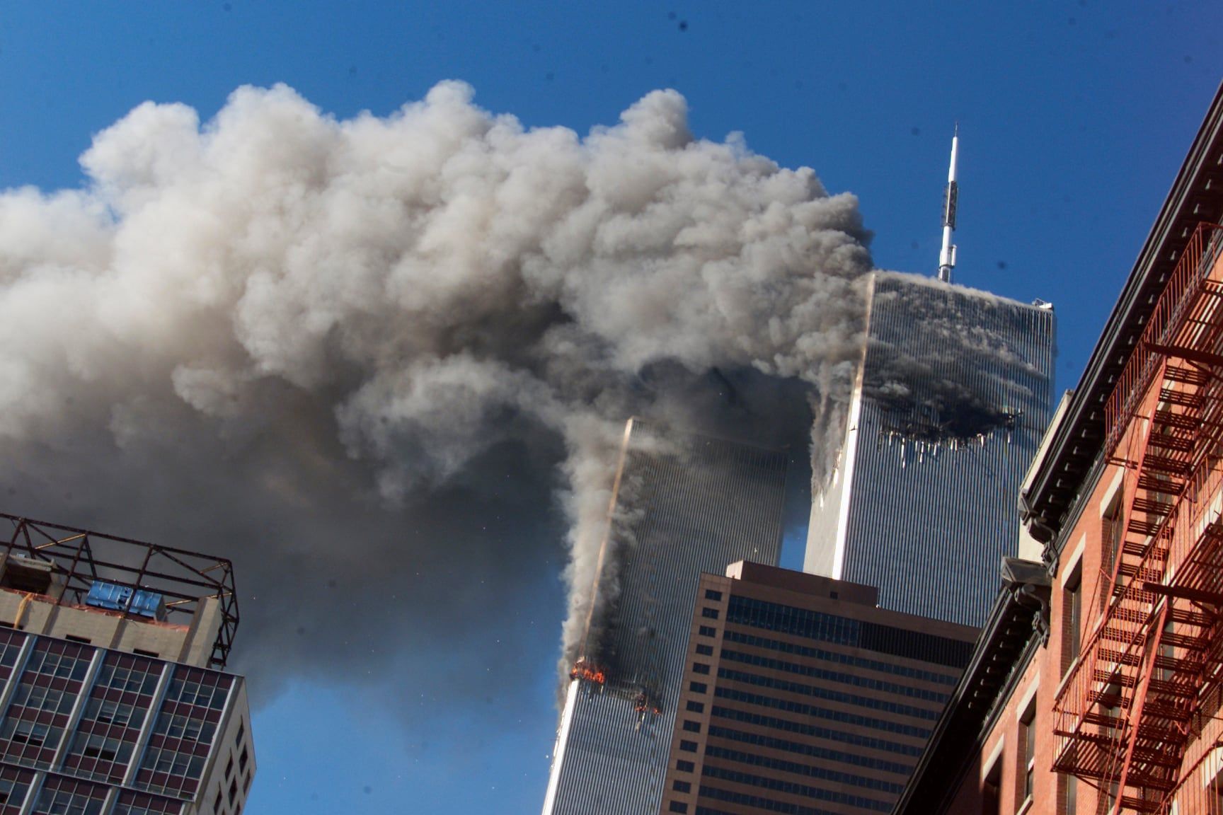 Smoke rises from the burning twin towers of the World Trade Center after hijacked planes crashed into the towers in New York City on Sept. 11, 2001. - AP Photo/Richard Drew, File