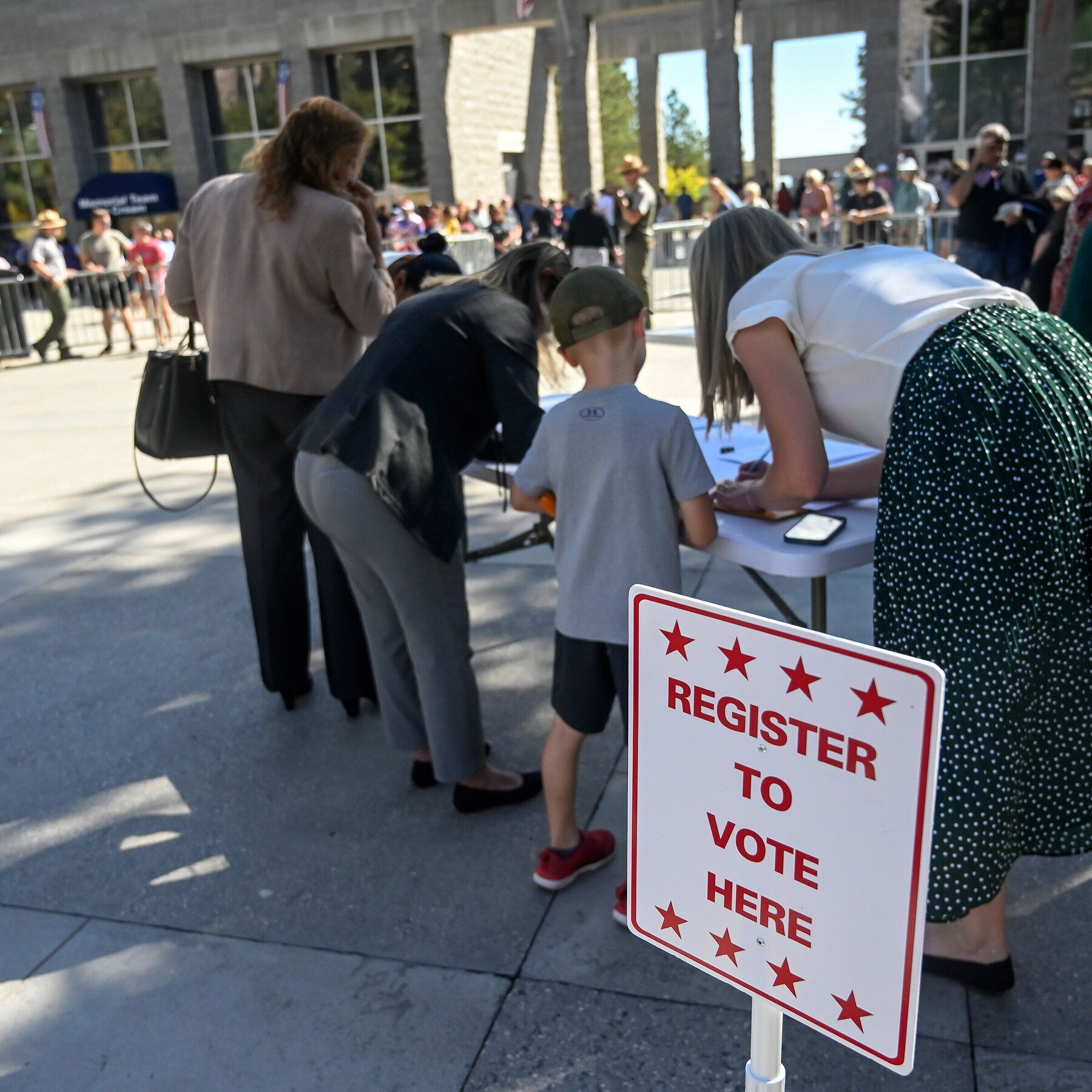 New citizens register to vote after a naturalization ceremony at Mount Rushmore in South Dakota. - AP