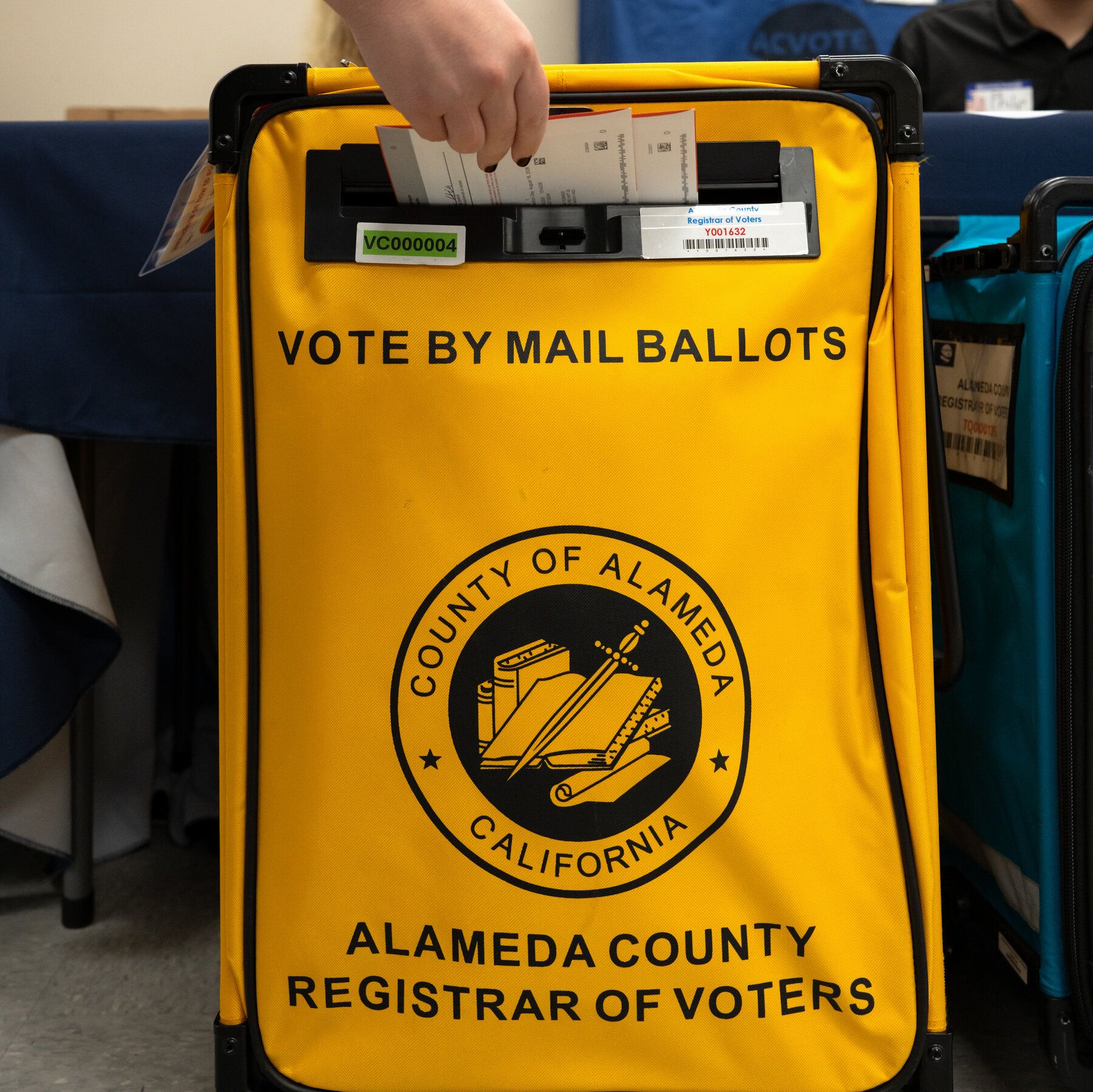 A resident drops off her mail ballot in Livermore, California. - The New York Times