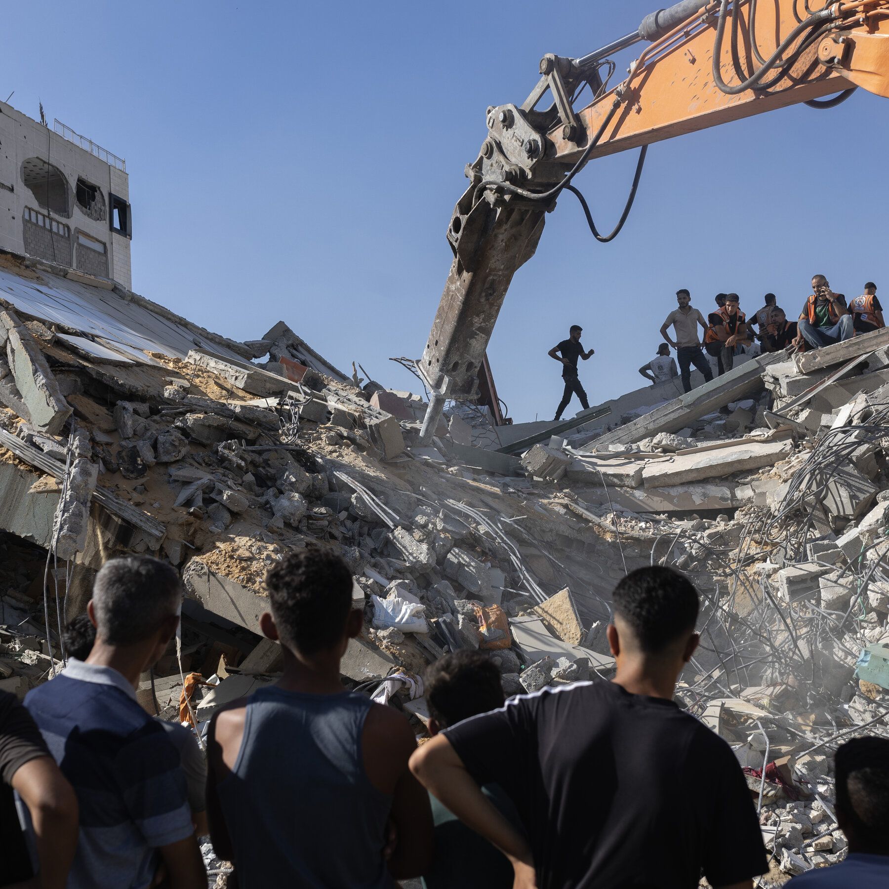 Excavating rubble from a collapsed building to recover bodies in Gaza City on Wednesday. - The New York Times