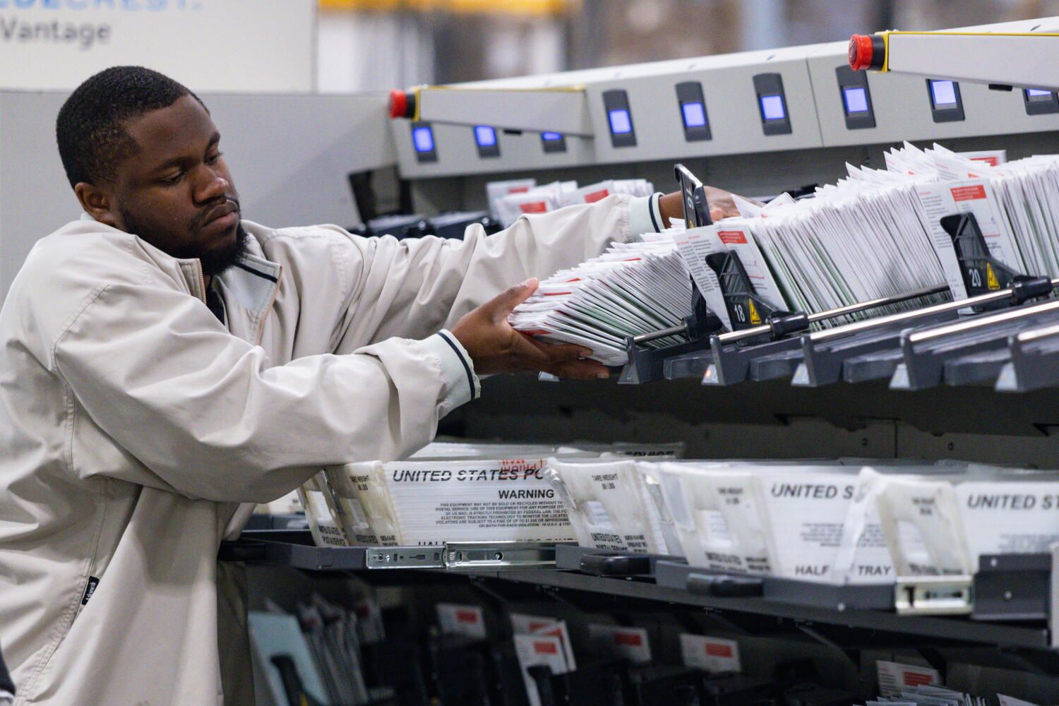 A worker places ballots into a counting machine at the Los Angeles County Ballot Processing Center in City of Industry, California, on June 3, 2026. - Kayla Bartkowski / Los Angeles Times