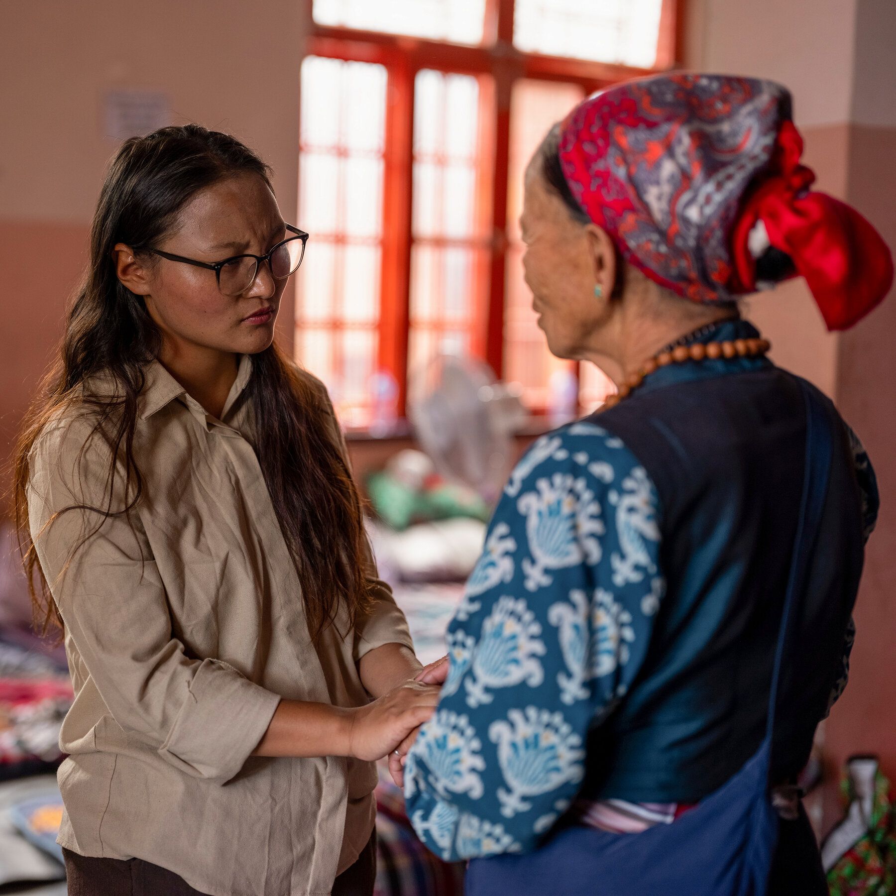 Climate activist Tashi Lhazom meets a woman displaced by floods at a Buddhist monastery in Kathmandu, Nepal. - nytimes.com