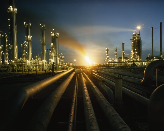 Gas flares illuminate a Saudi Aramco plant in Ras Tanura, Saudi Arabia. - Thomas J Abercrombie/National Geographic/Getty Images