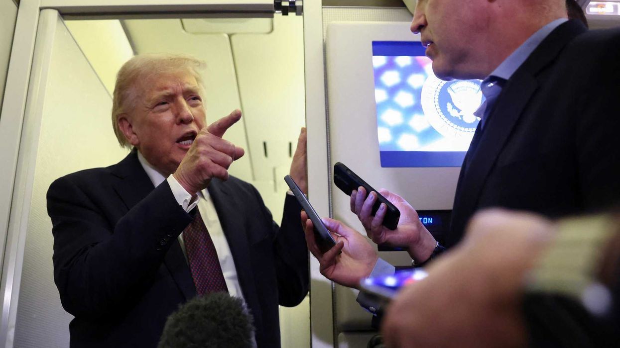 President Trump speaks to reporters aboard Air Force One. - Kevin Lamarque/Reuters