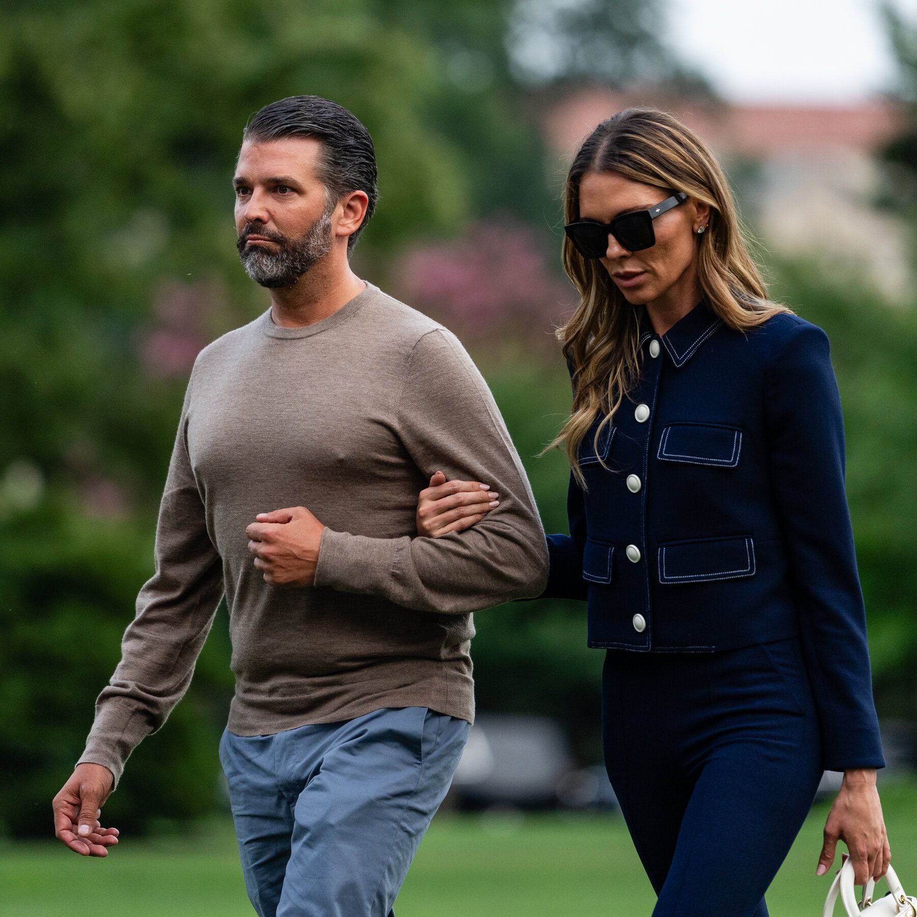 Donald Trump Jr. with his wife Bettina Anderson in July; Sen. John Curtis called for a Senate investigation into his finances. - The New York Times