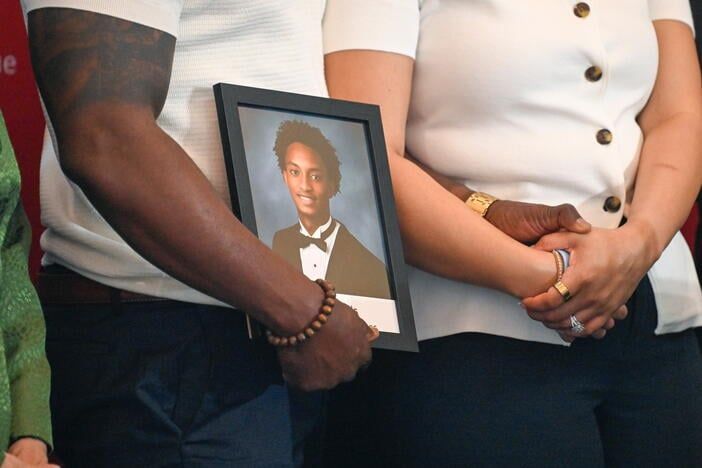 Christine Wonsley and Elmore Wonsley appear with a photograph of Nolan Wells at a news conference. - AP Photo